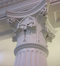 Photo showing ornamentatation on a column capital in the library.